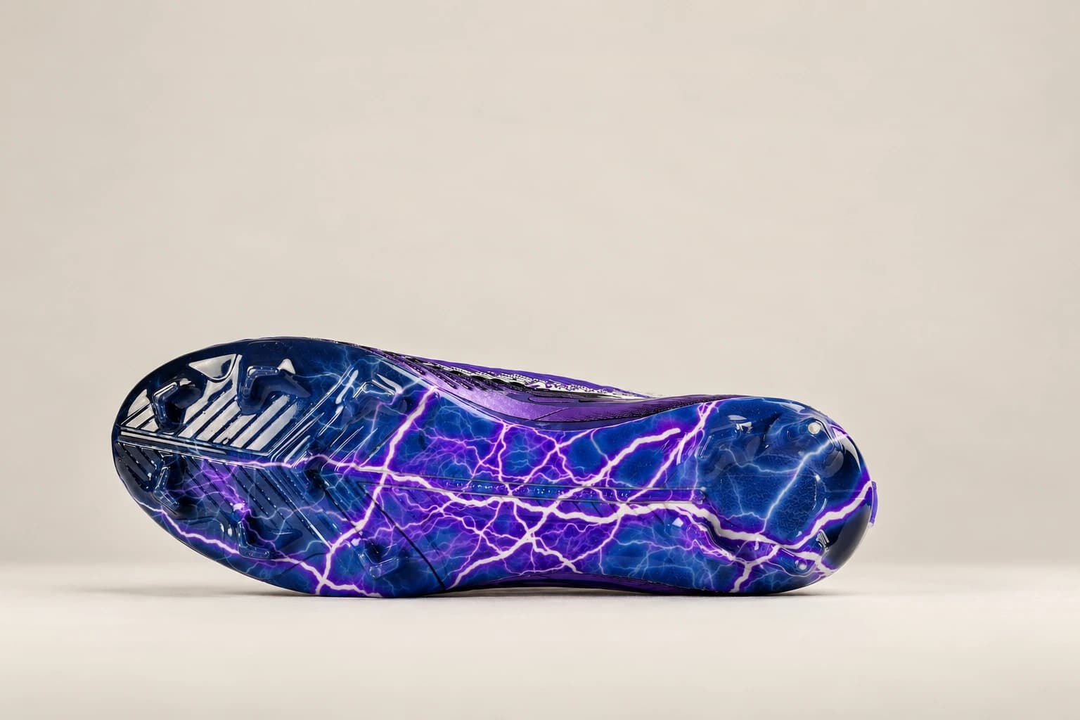 The Stravion Purple lightning-print soleplate and stud layout.
